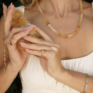 Close-up of woman wearing raw citrine beaded necklace, prosperity consciousness crystal healing jewelry