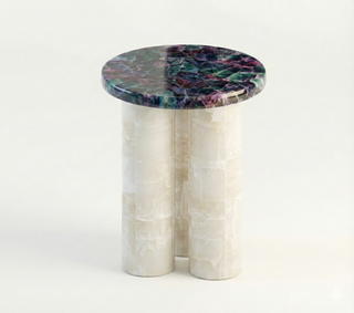 Fluorite and onyx side table with mosaic stone top on white column base, product shot.
