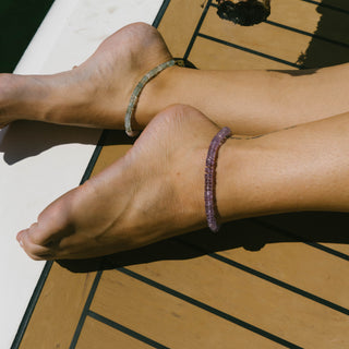 Woman wearing Sanamama raw amethyst beaded anklets, Saint Germain violet flame transformation jewelry 18k gold