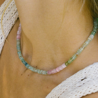 Woman wearing Sanamama raw aquamarine beaded necklace, Saint Germain emotional healing crystal jewelry 18k gold