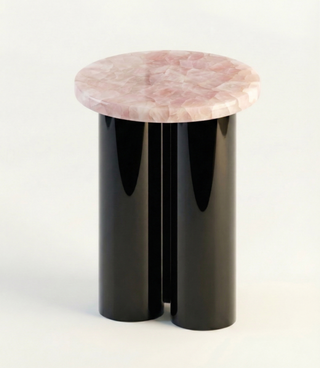 Rose quartz top side table on black onyx cylindrical base, product shot on white.
