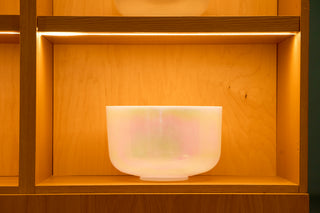 Large 12-inch Saint Germain sky alchemy bowl with soft iridescent glow on lit wood shelf.
