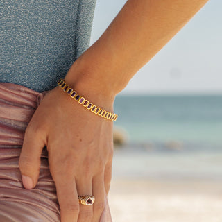 Saint Germain tennis bracelet with amethyst and pink tourmaline, beach lifestyle, wrist detail.