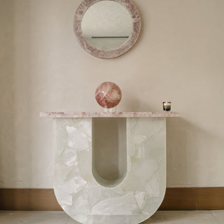 Rose quartz U-console table with matching circular pink quartz mirror in the Sanamama sanctuary